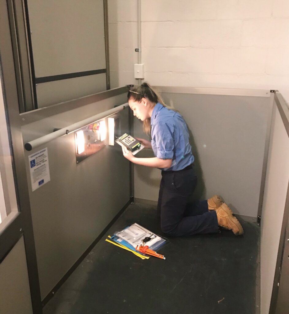 A Simplex technician inspecting an elevator