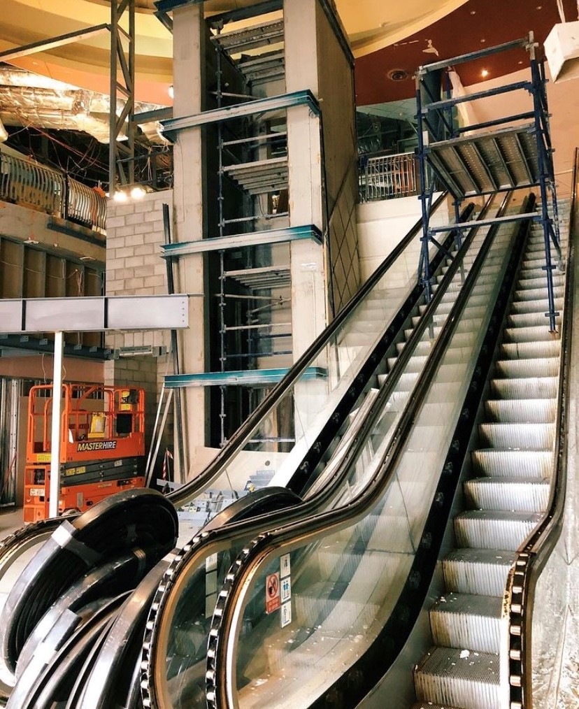 An escalator being installed in a commercial building