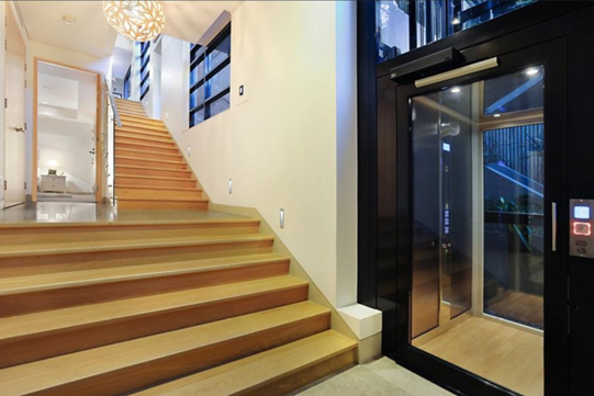 internal timber stairs with a home lift