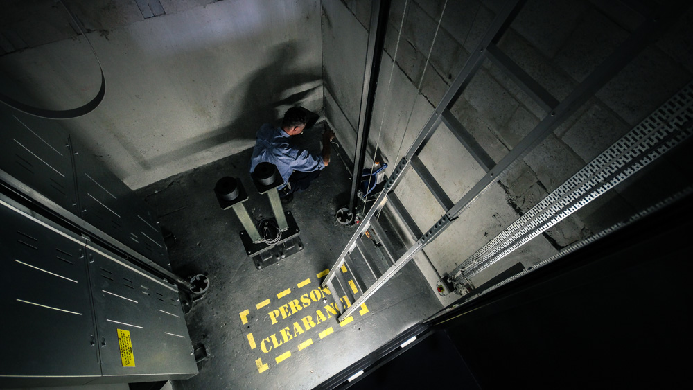Simplex Elevator technician fixing a lift